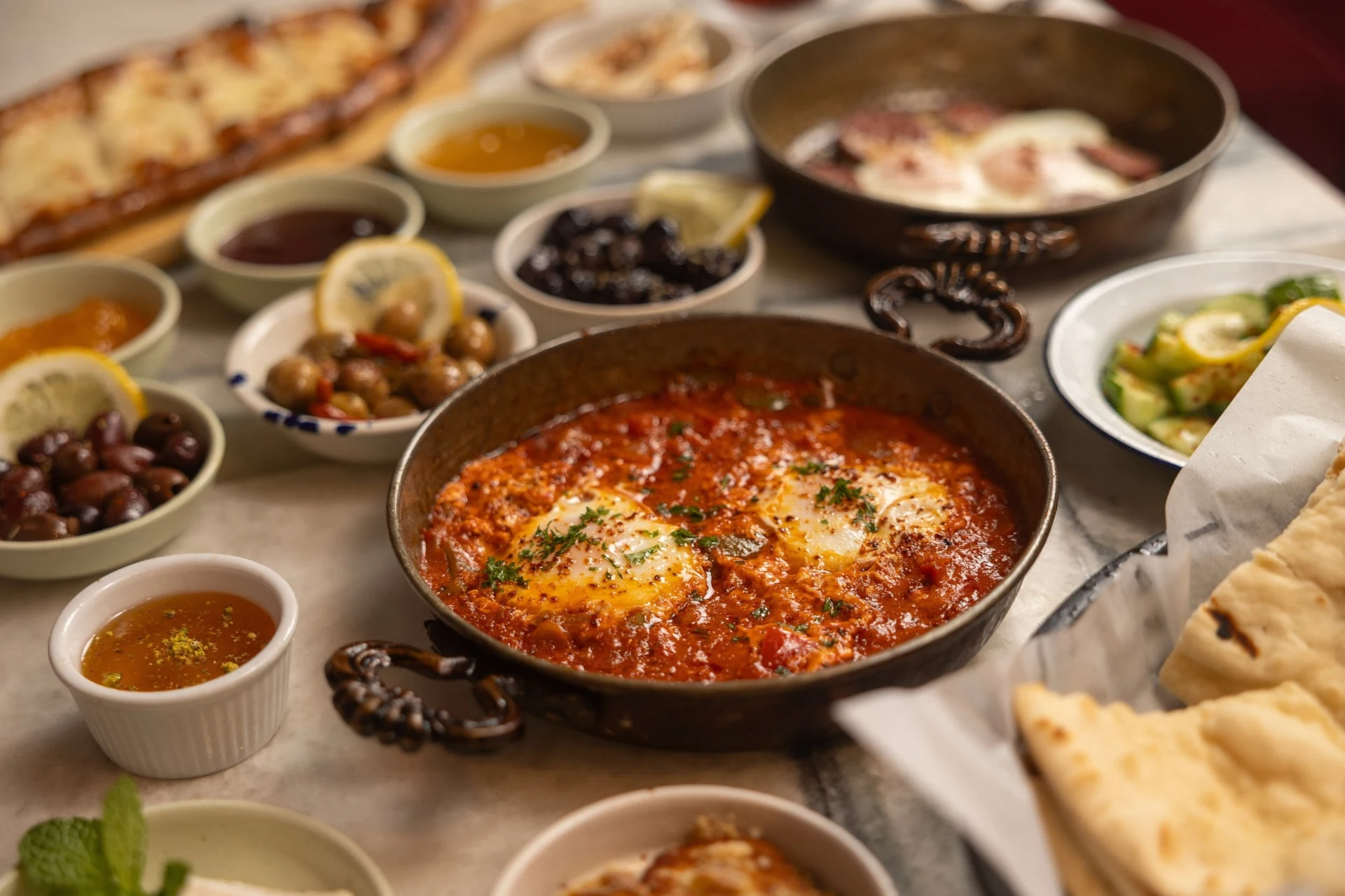 Turkish breakfast spread at Sivas with menemen, olives, honey and fresh bread
